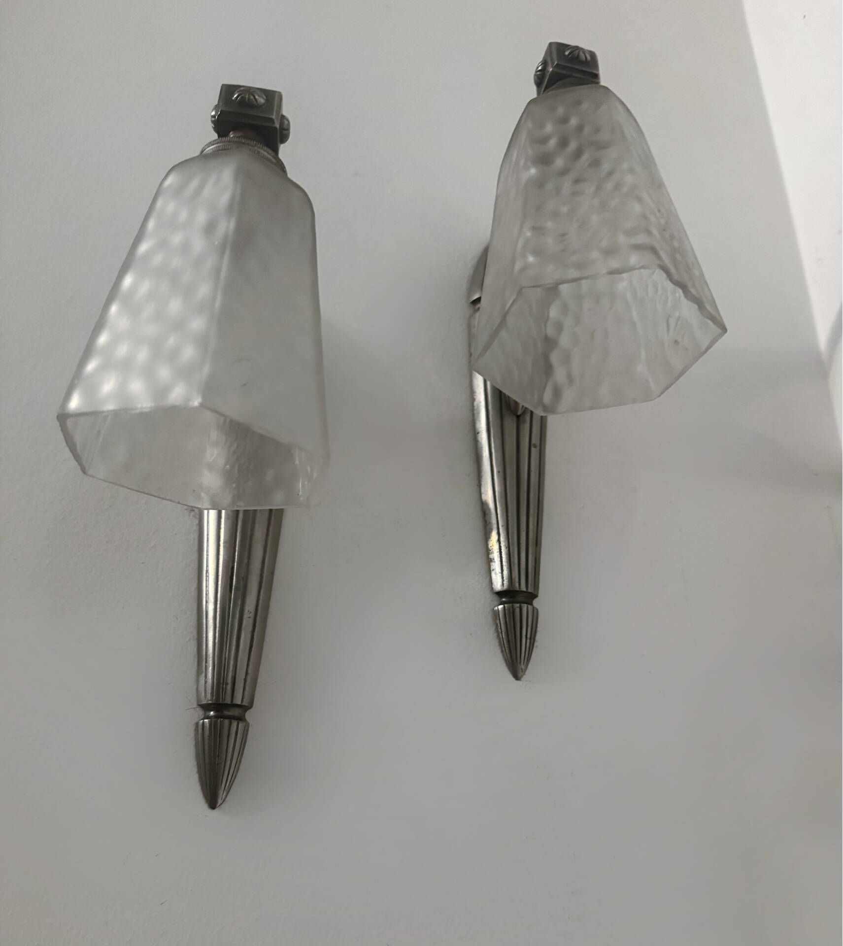 Silver Art Deco wall lights with frosted glass.