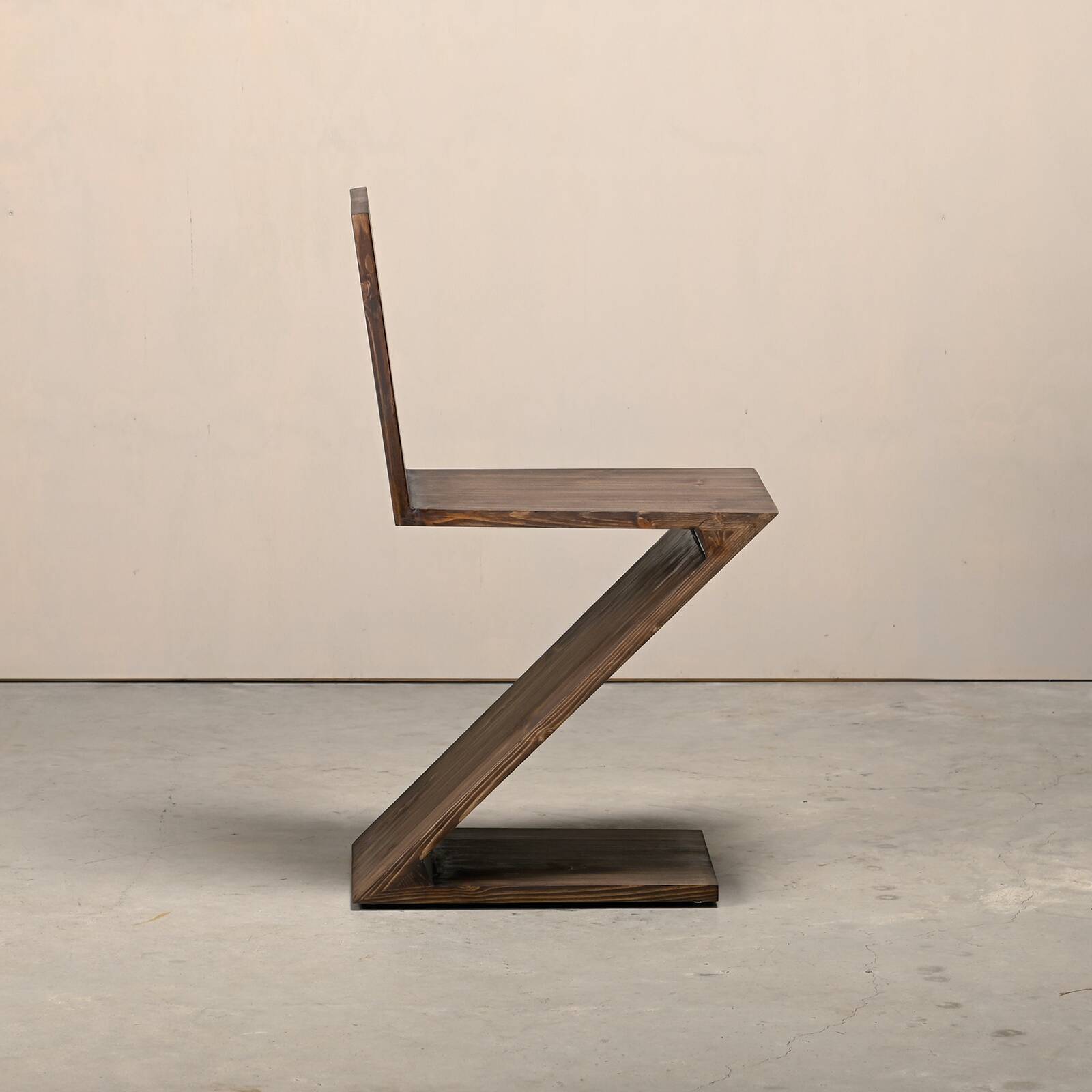 Gerrit Rietveld Zig Zag Chair is dark brown stained wood