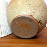 Large stone lamp with a cotton shade.