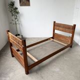Brutalist style bed with chain and straw