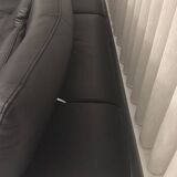 2 black leather sofas roche bobois scenario, one three-seater and one chaise longue.