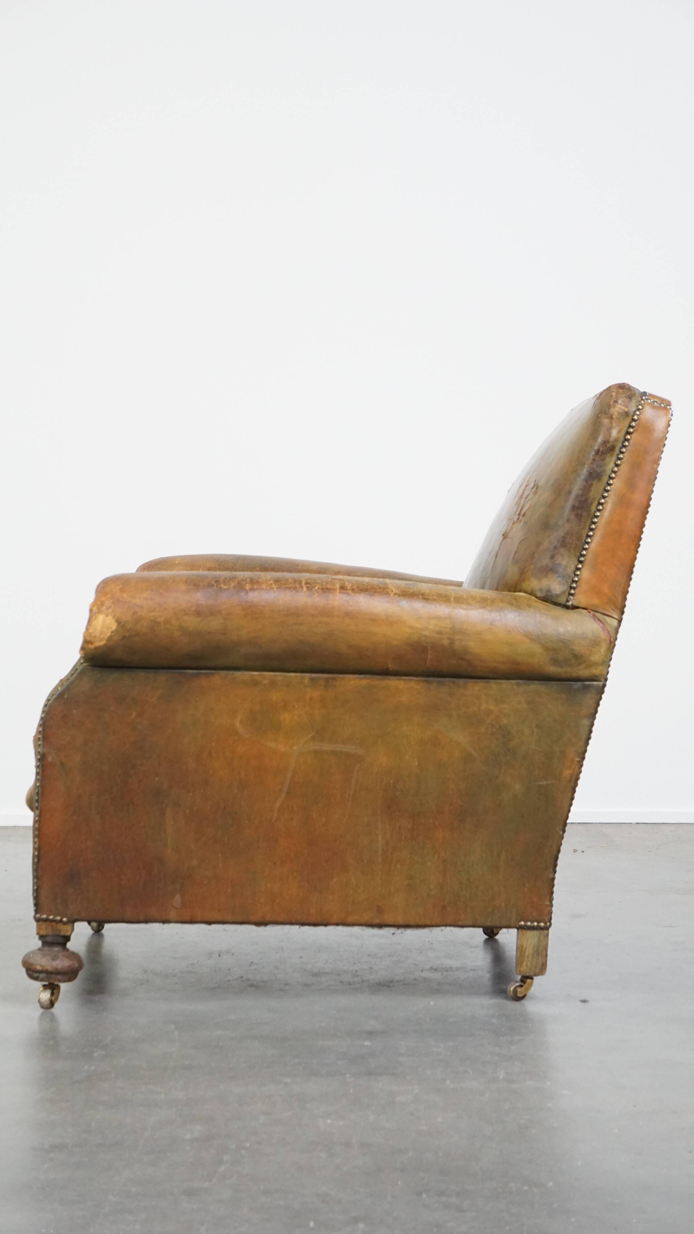 Green antique English cowhide leather armchair on wheels