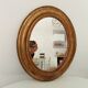 Louis Philippe 19th century oval gilded mirror in wood and stucco
