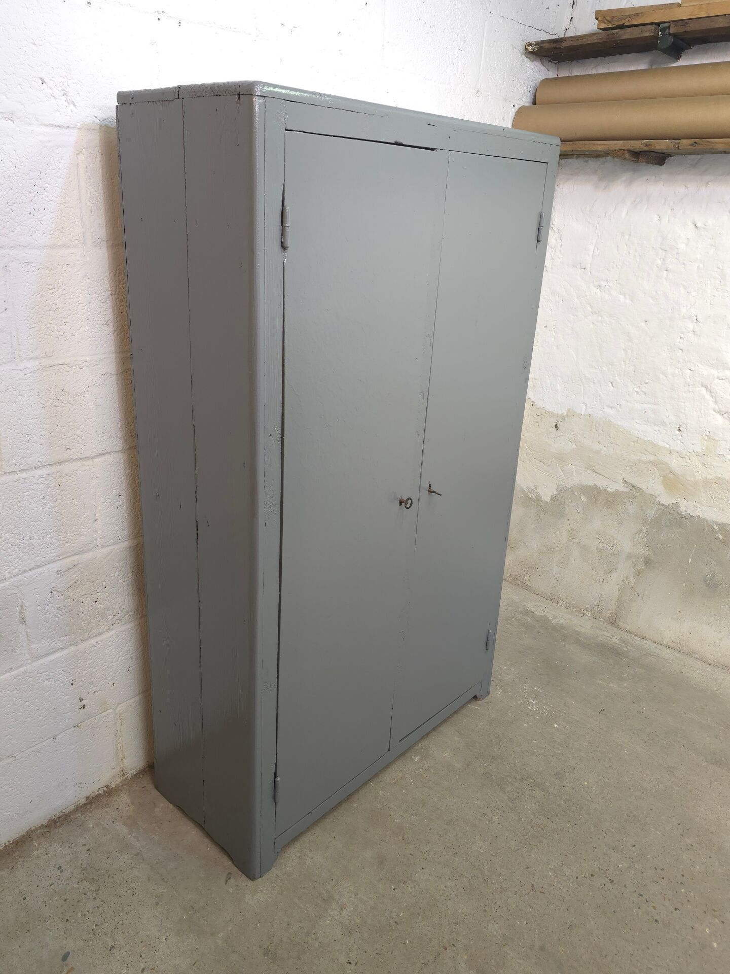 Curved wardrobe workshop locker made of wood repainted in grey.