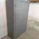 Curved wardrobe workshop locker made of wood repainted in grey.