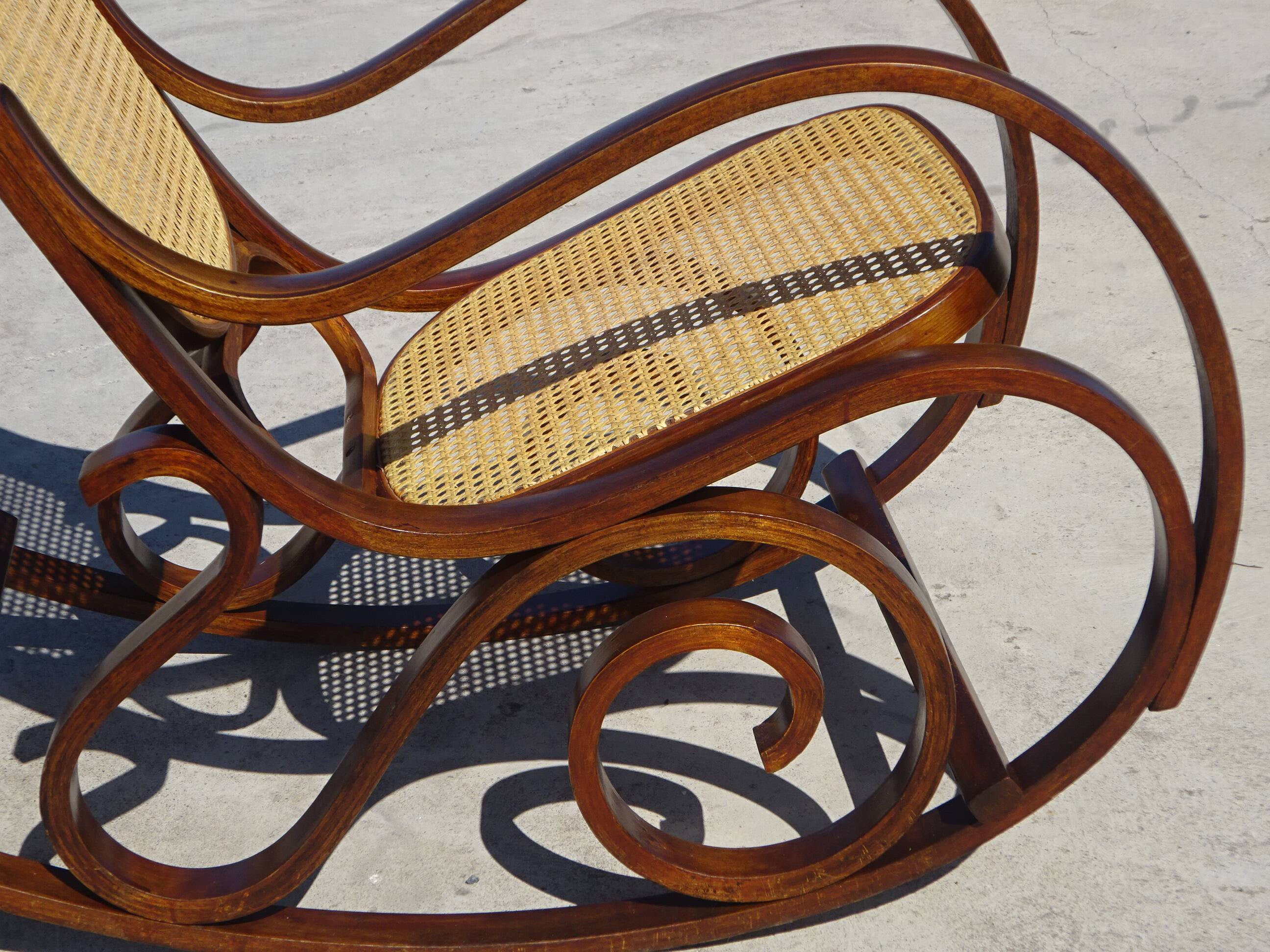 Vintage wooden rocking chair with caning