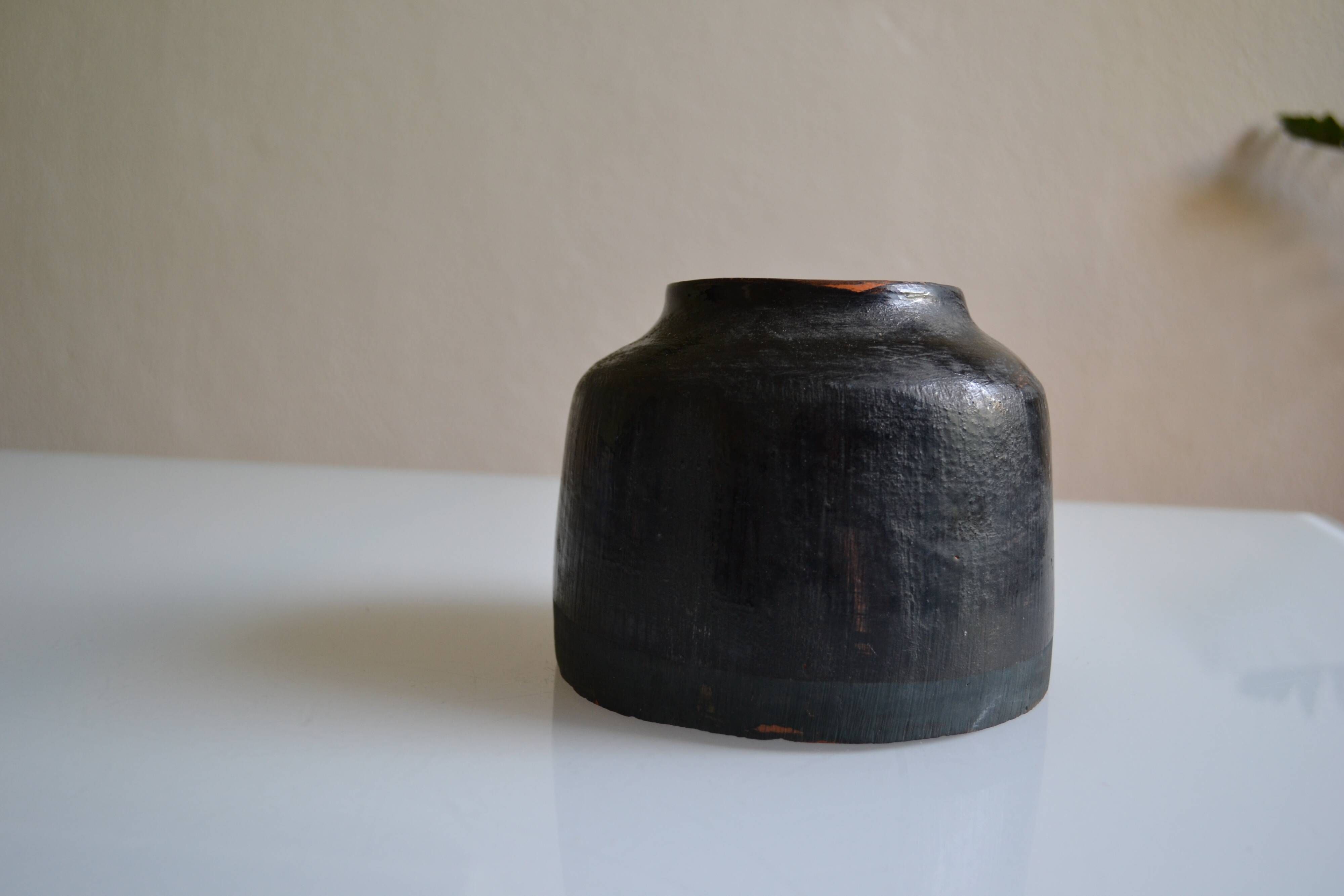 Ceramic vase with a signature fish to identify.