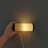 Old wall lamp, made of bakelite with a vanilla/egg colored glass shade.