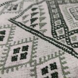 Handwoven white and green rug