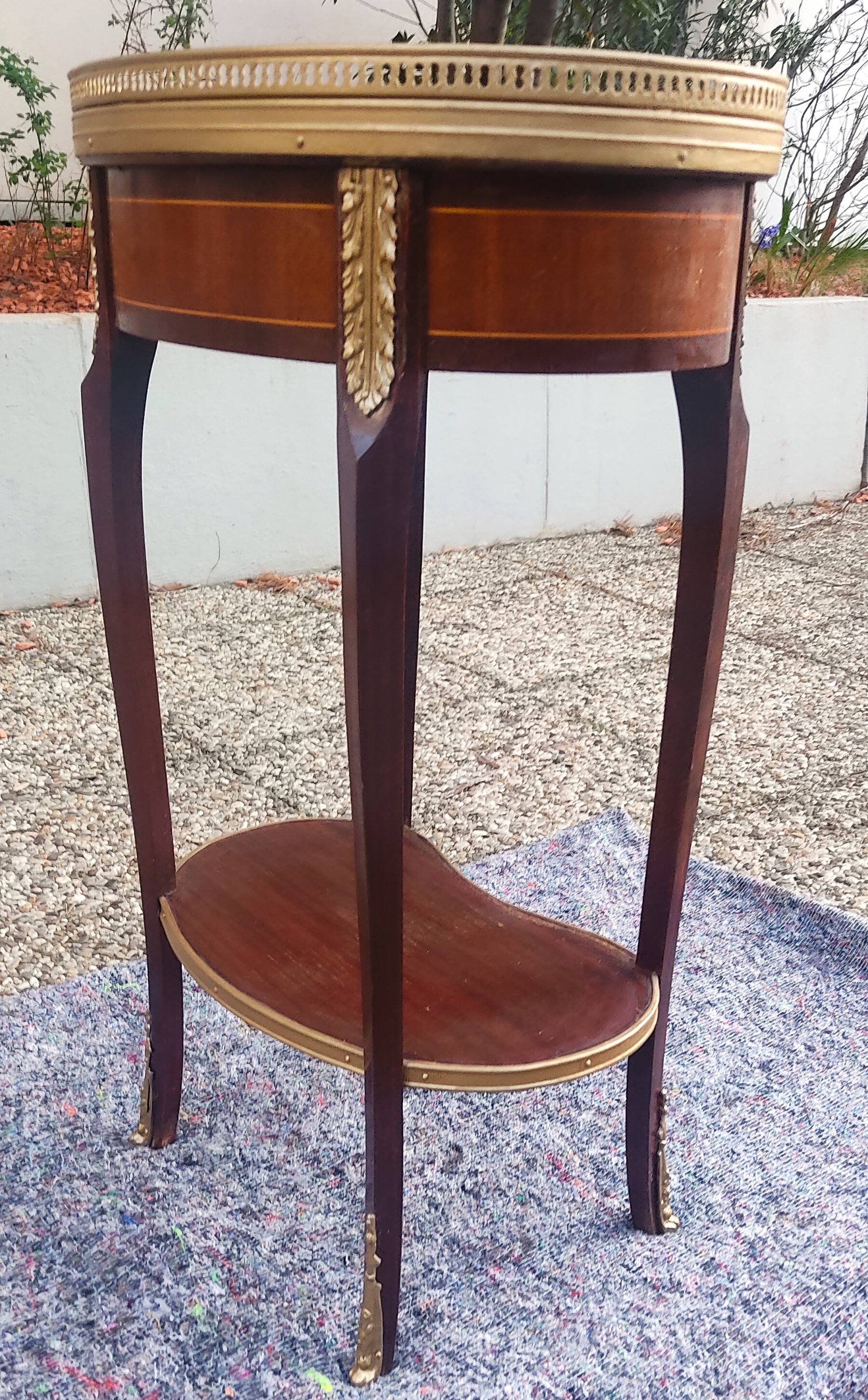 Louis XVI period pedestal table, in solid mahogany and veneer, and in gilded bronze.