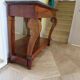 Empire/Restoration style console table with scrolled ends, mirrored back, and claw feet.