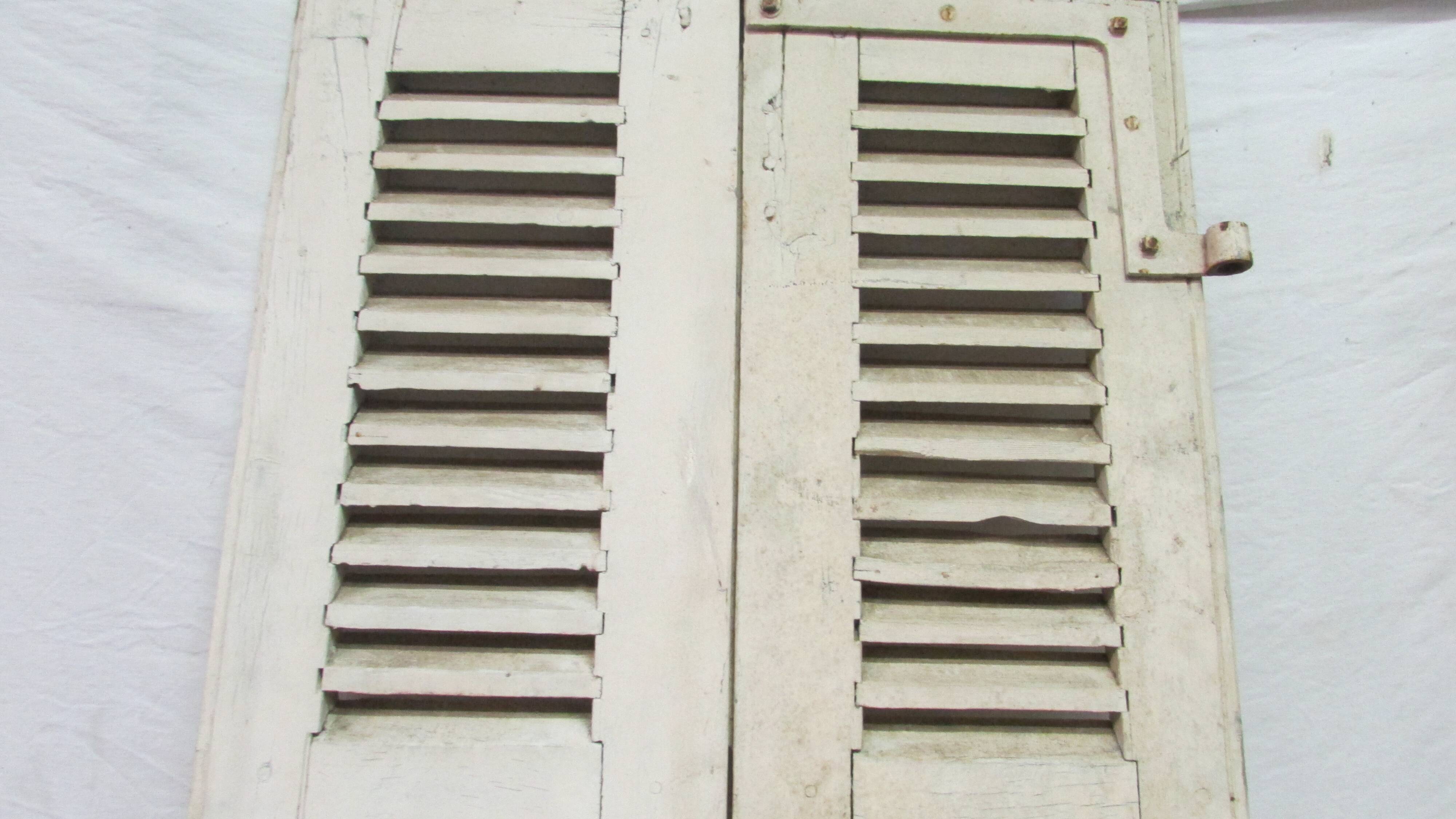Old shutter in folding wooden louver