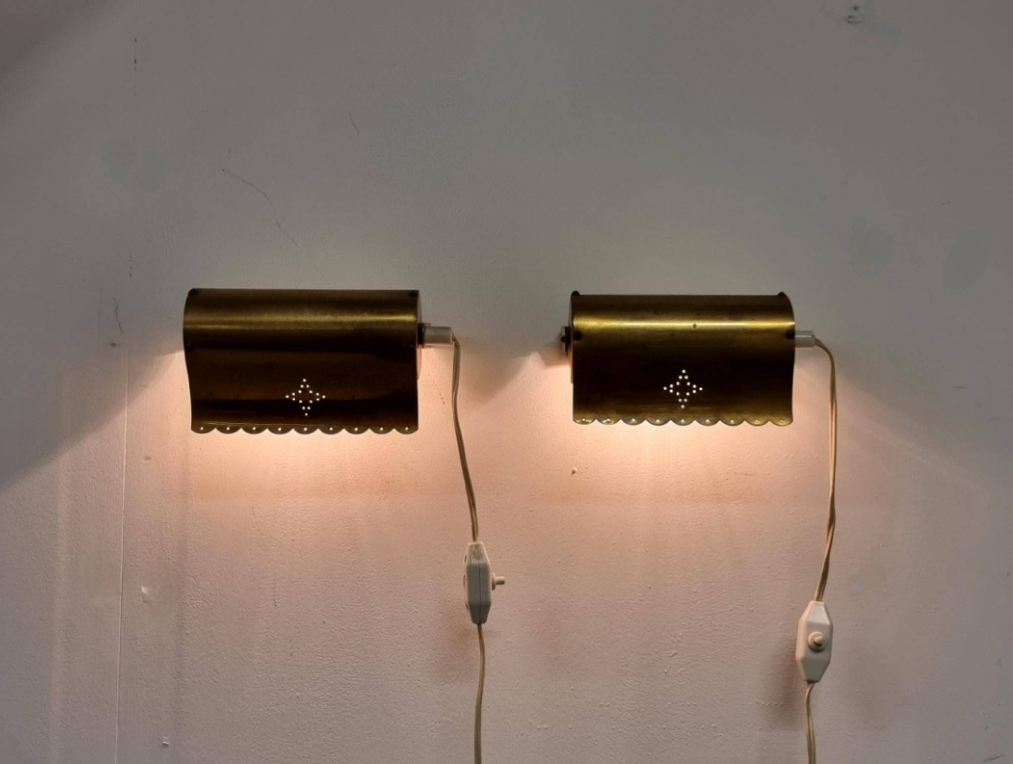 A pair of charming wall sconces/branches in brass with a star pattern, modern Scandinavian style.