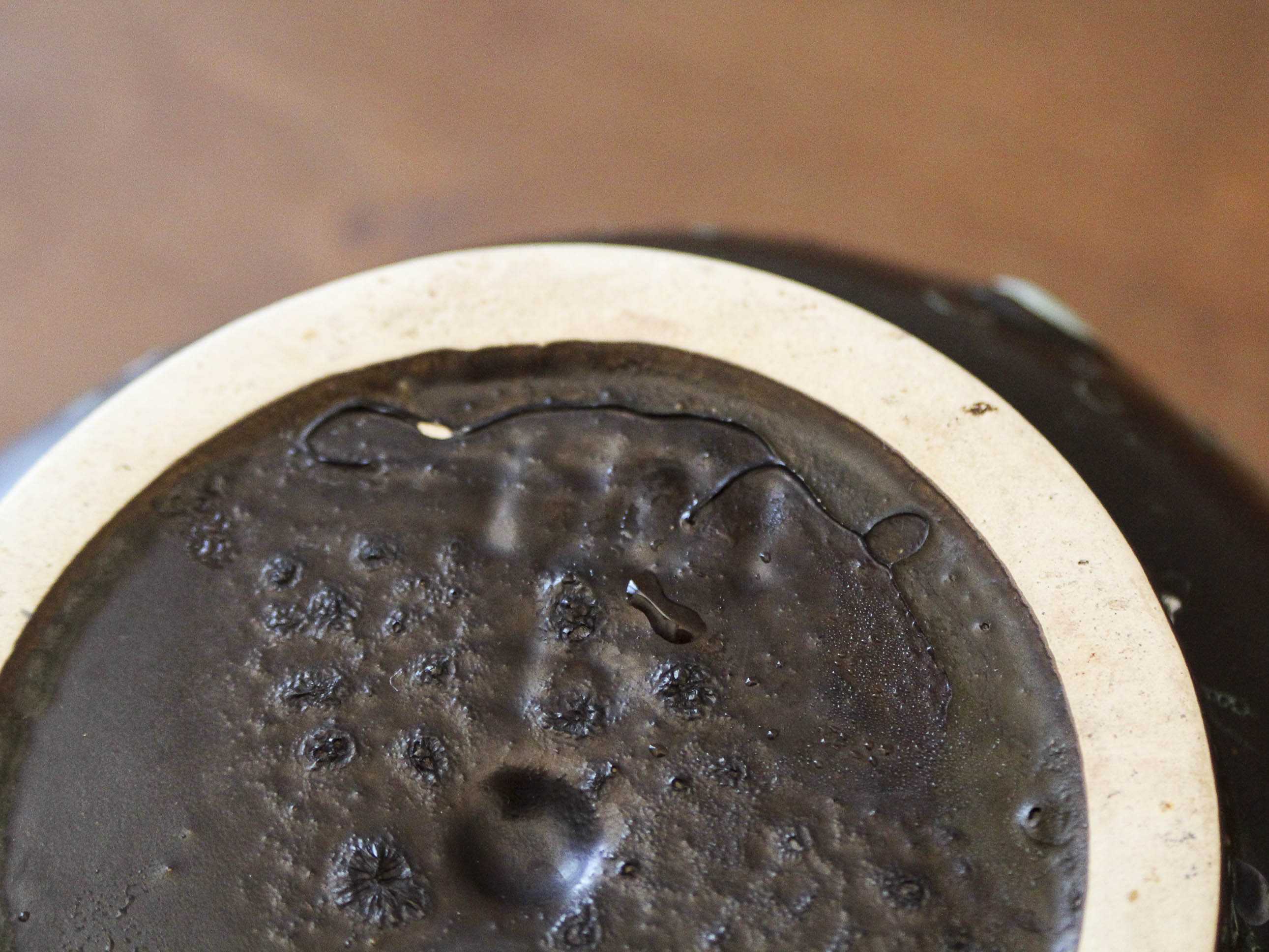 Empty pocket in black ceramic with green drip