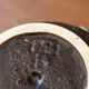 Empty pocket in black ceramic with green drip