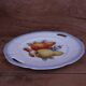 Set of 7 dessert plates and a cake stand with fruit patterns.