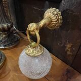 Vintage wall light in gilded bronze with a cracked glass globe.