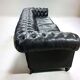 Large and old four-seater leather chesterfield sofa early 20th century l 260 cm
