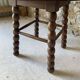 Round wooden coffee table with turned legs.