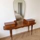 Vintage 1950s wooden vanity with mirror.