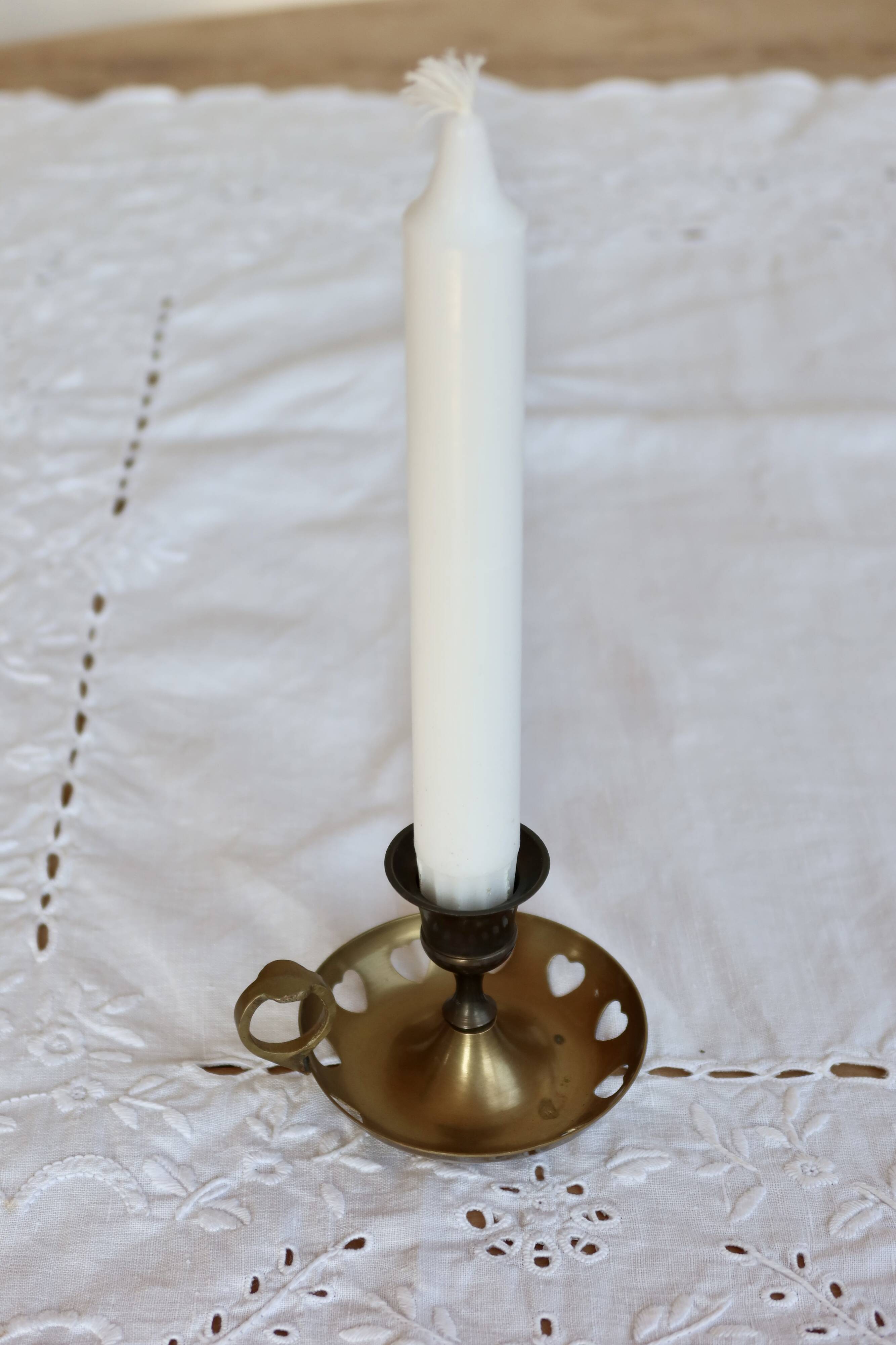 Antique brass rat trap with heart patterns.