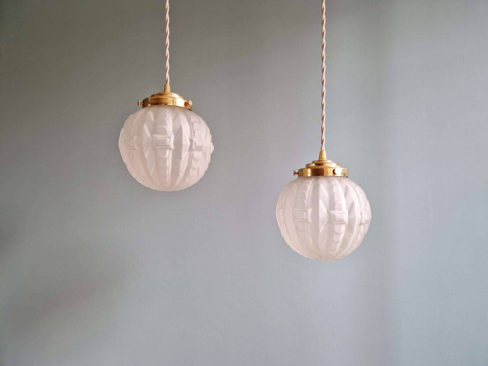 Pair of Art Deco pendant lights in pressed molded satin glass, 1920-30