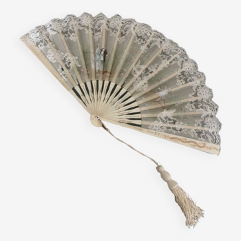 Old fan from the beginning of the 20th century with lace and painted decoration