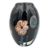 Double-lined blown glass vase with flower inclusions.