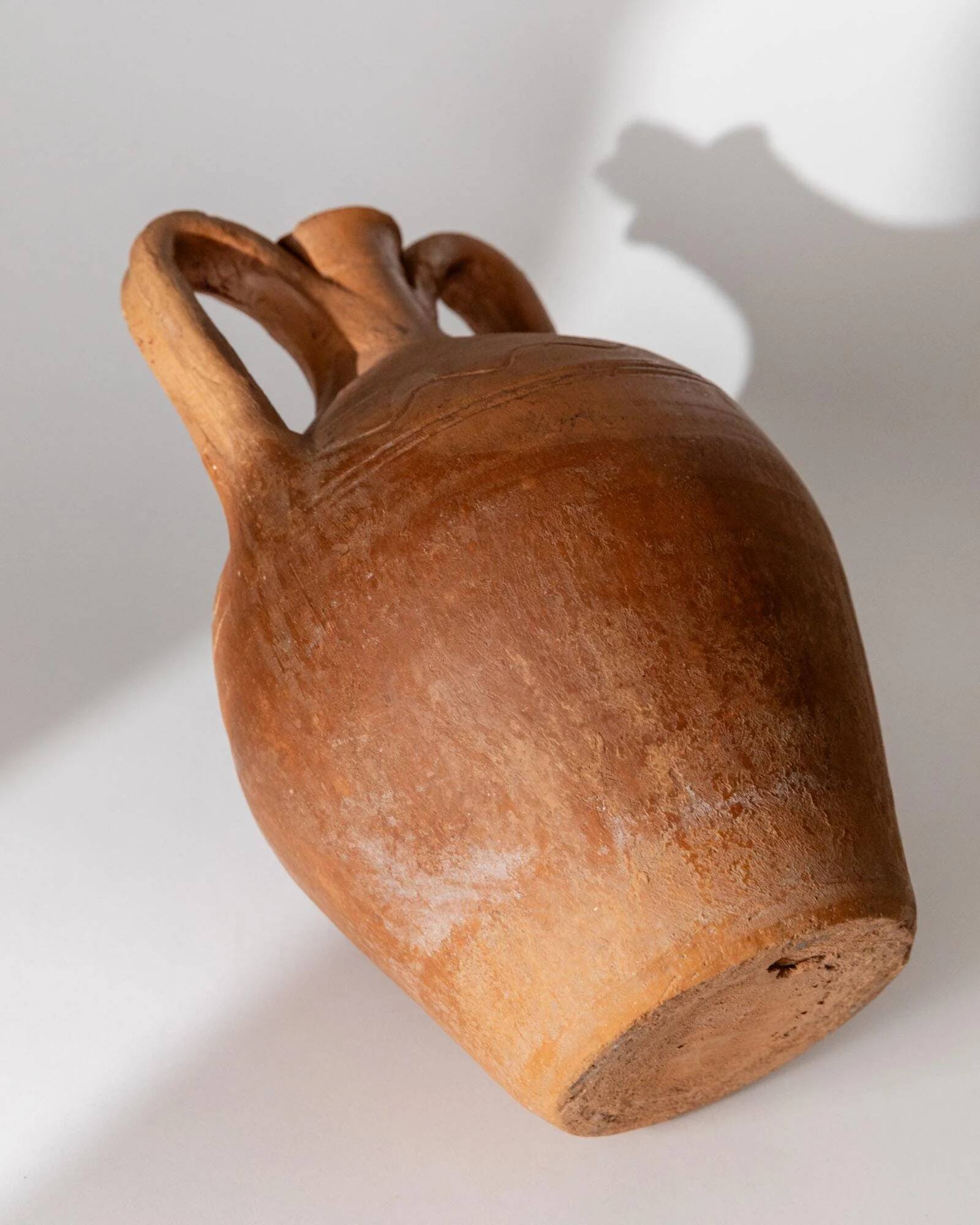 Vintage terracotta amphora vase from the early 19th century, handmade Italian jug with two handles.