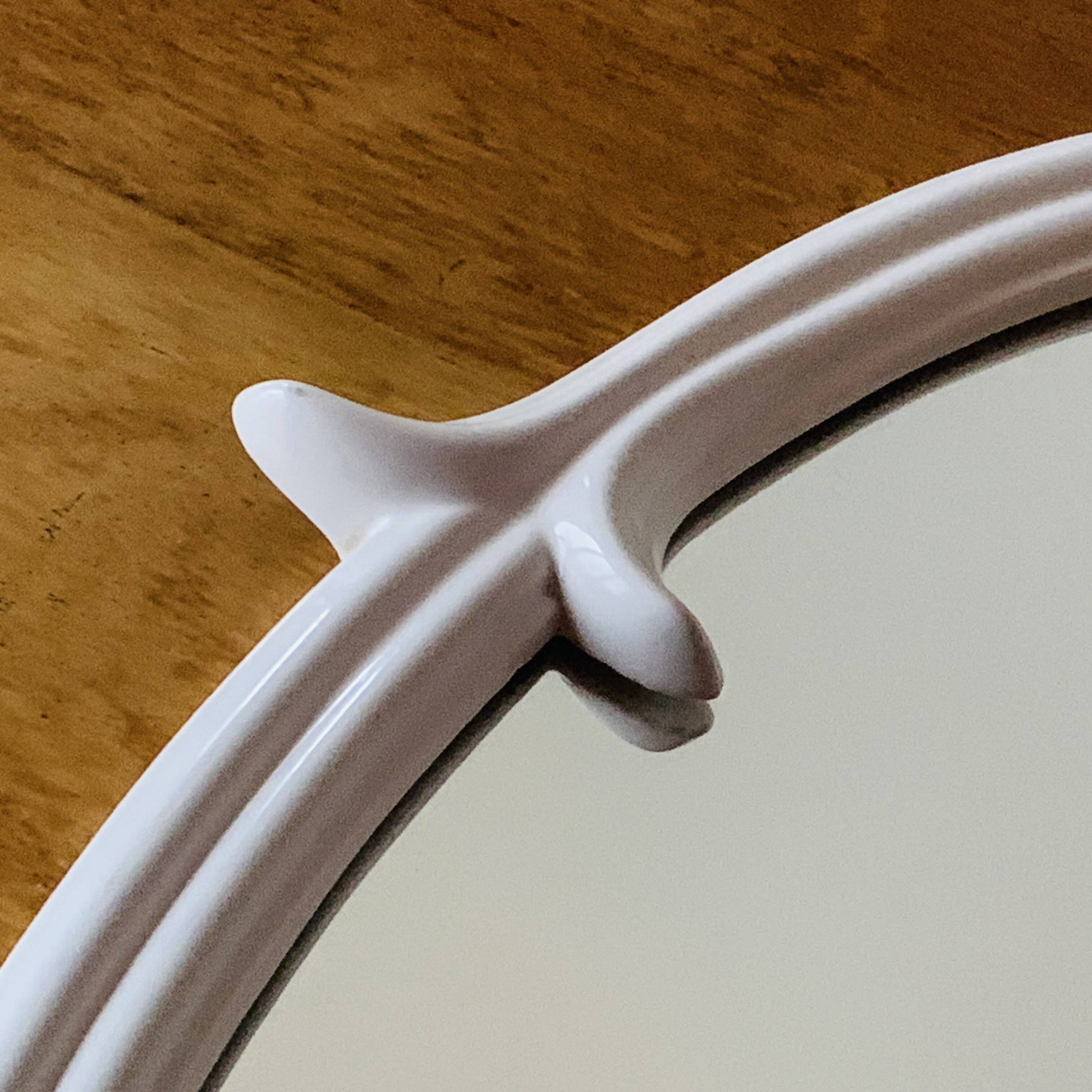 Oval mirror in vintage enameled white cast iron