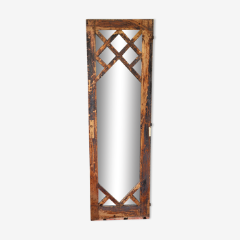 Wooden mirror mounted on old door