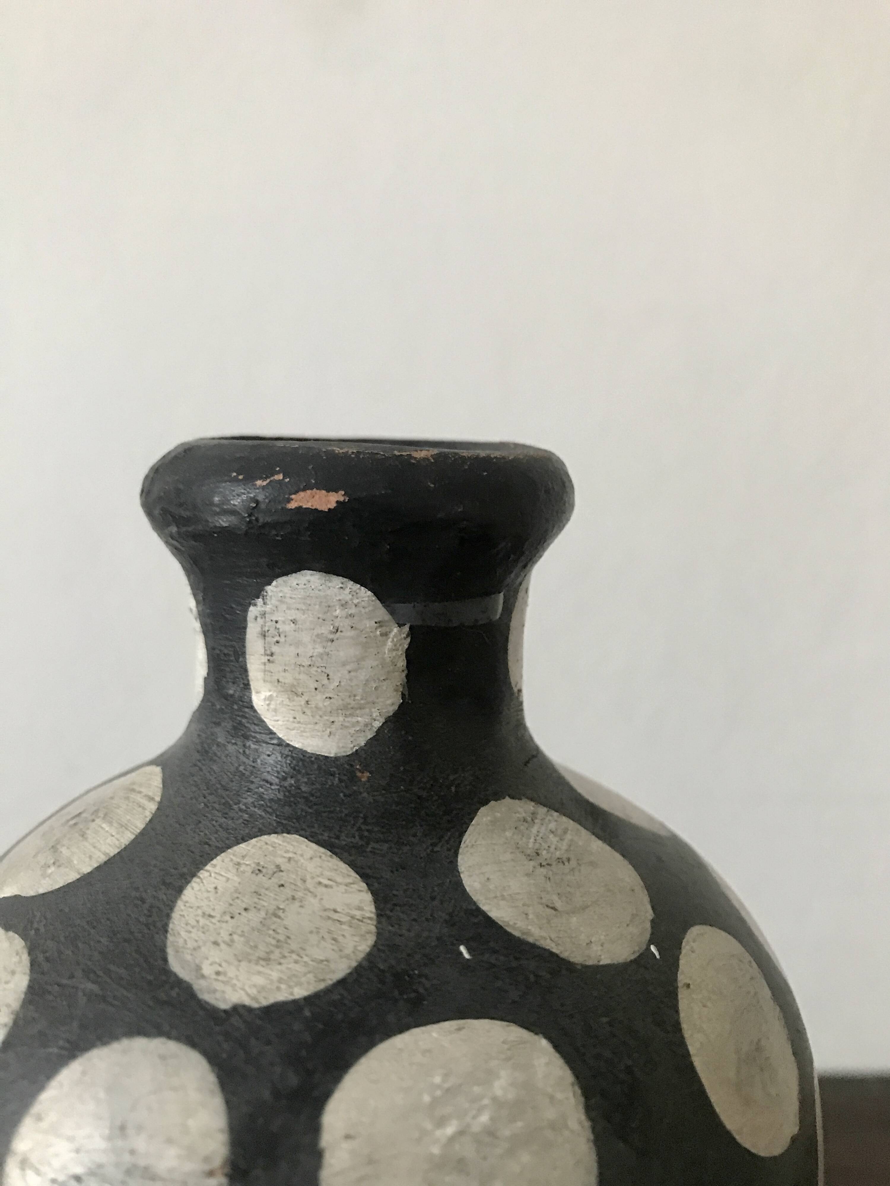 Terracotta vase painted with polka dots