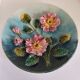 Decorative plate with relief floral pattern in majolica.