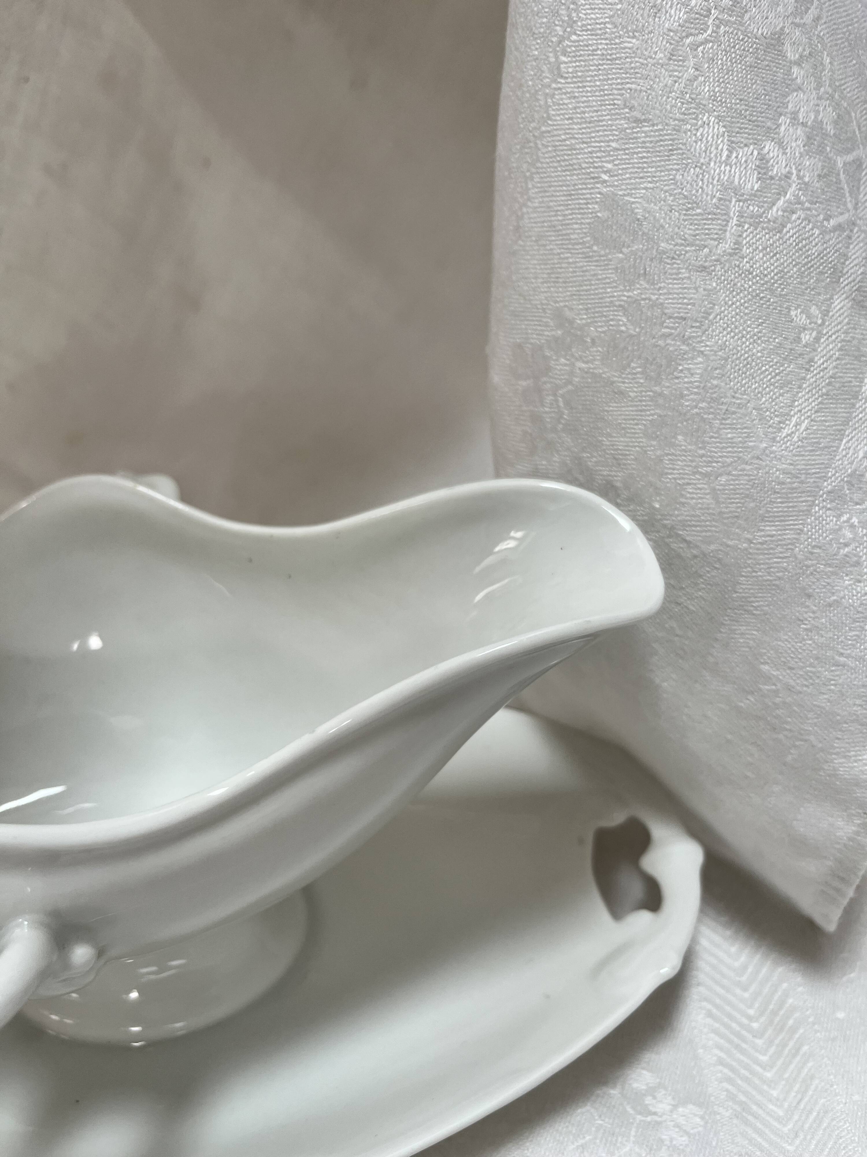 White porcelain sauce boat on tray