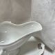 White porcelain sauce boat on tray