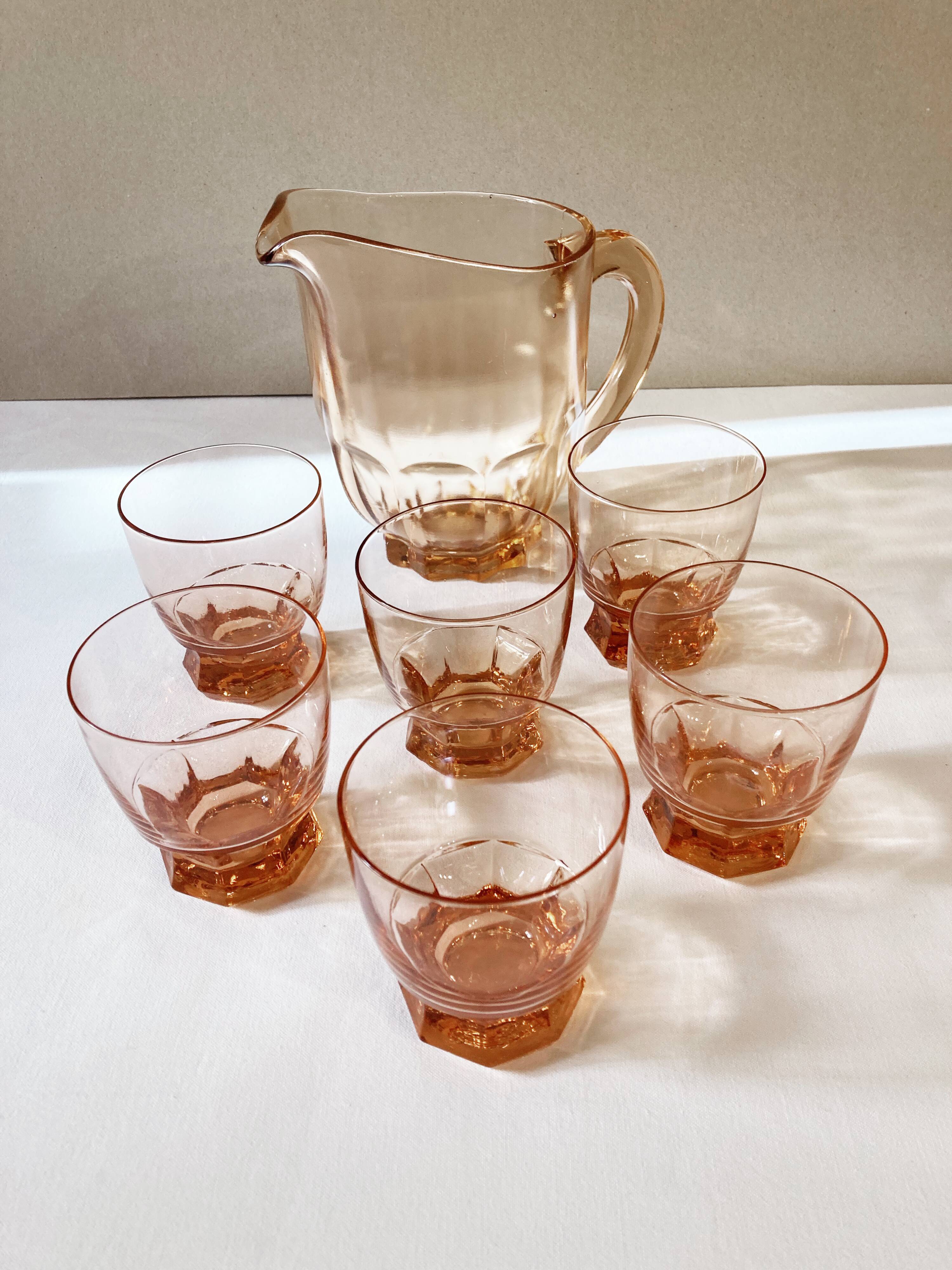 Pitcher and 6 water glasses in pink glass