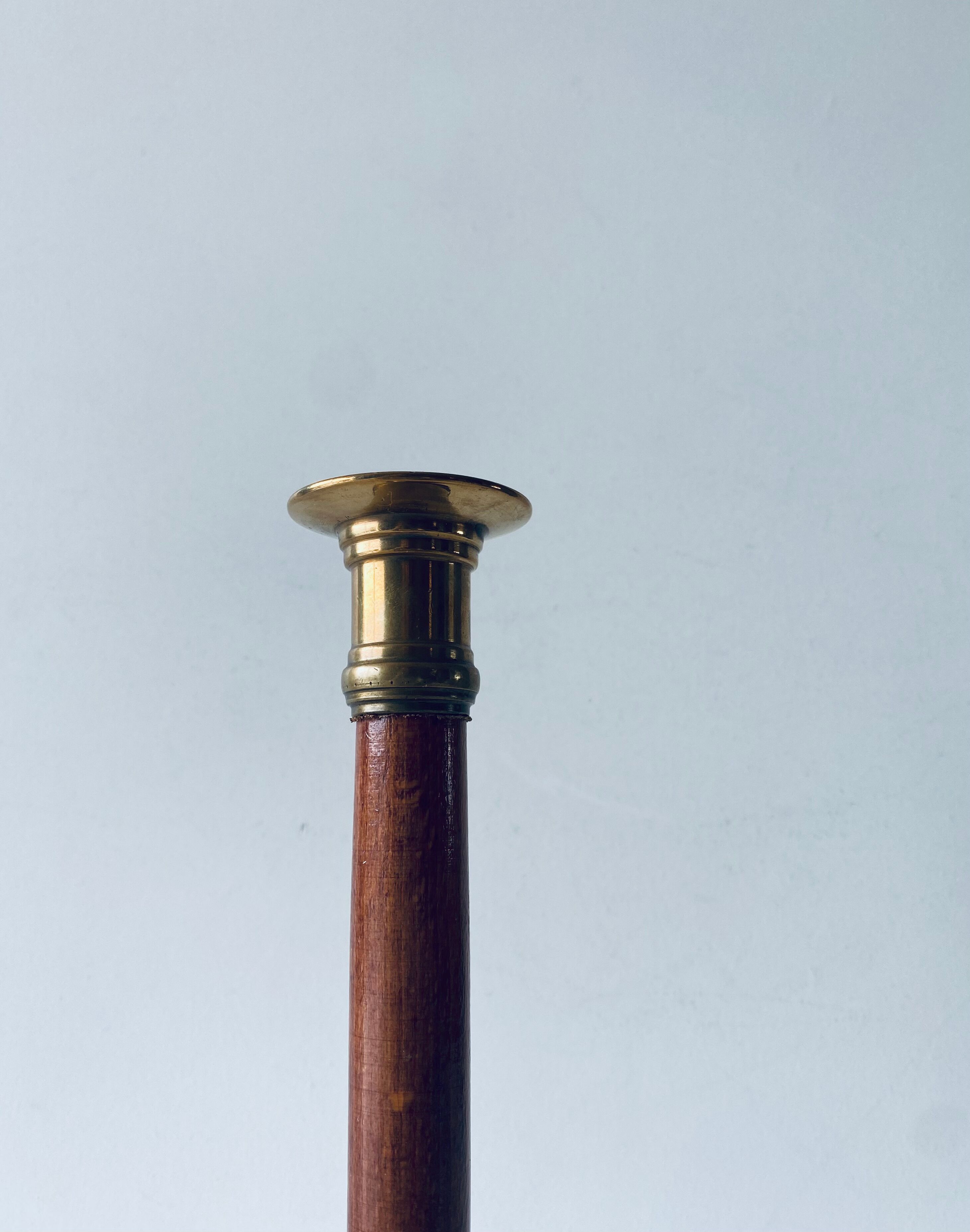 Old candle holder in brass and wood