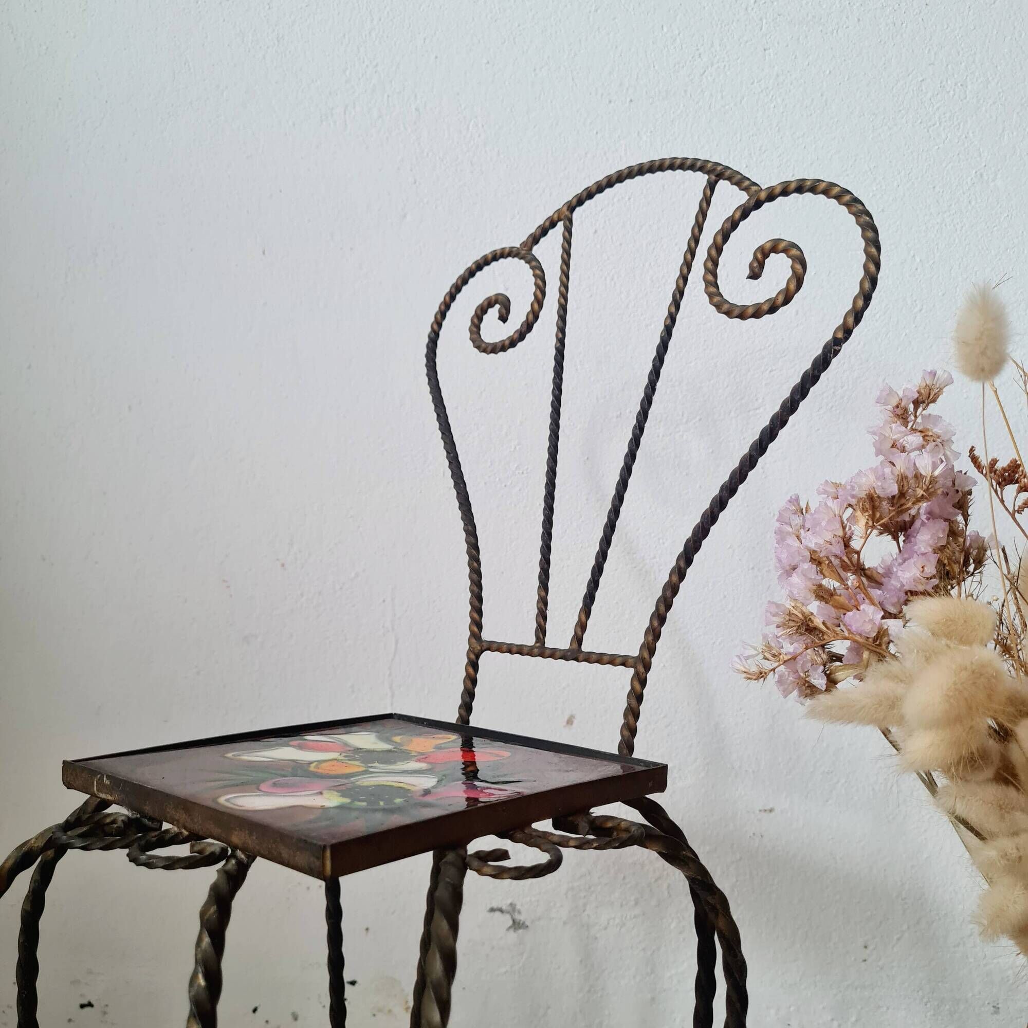 Small chair / stool in twisted wrought iron and floral ceramic.
