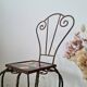 Small chair / stool in twisted wrought iron and floral ceramic.
