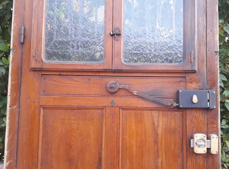 Oak entrance door and its frame and transom, wrought iron gates