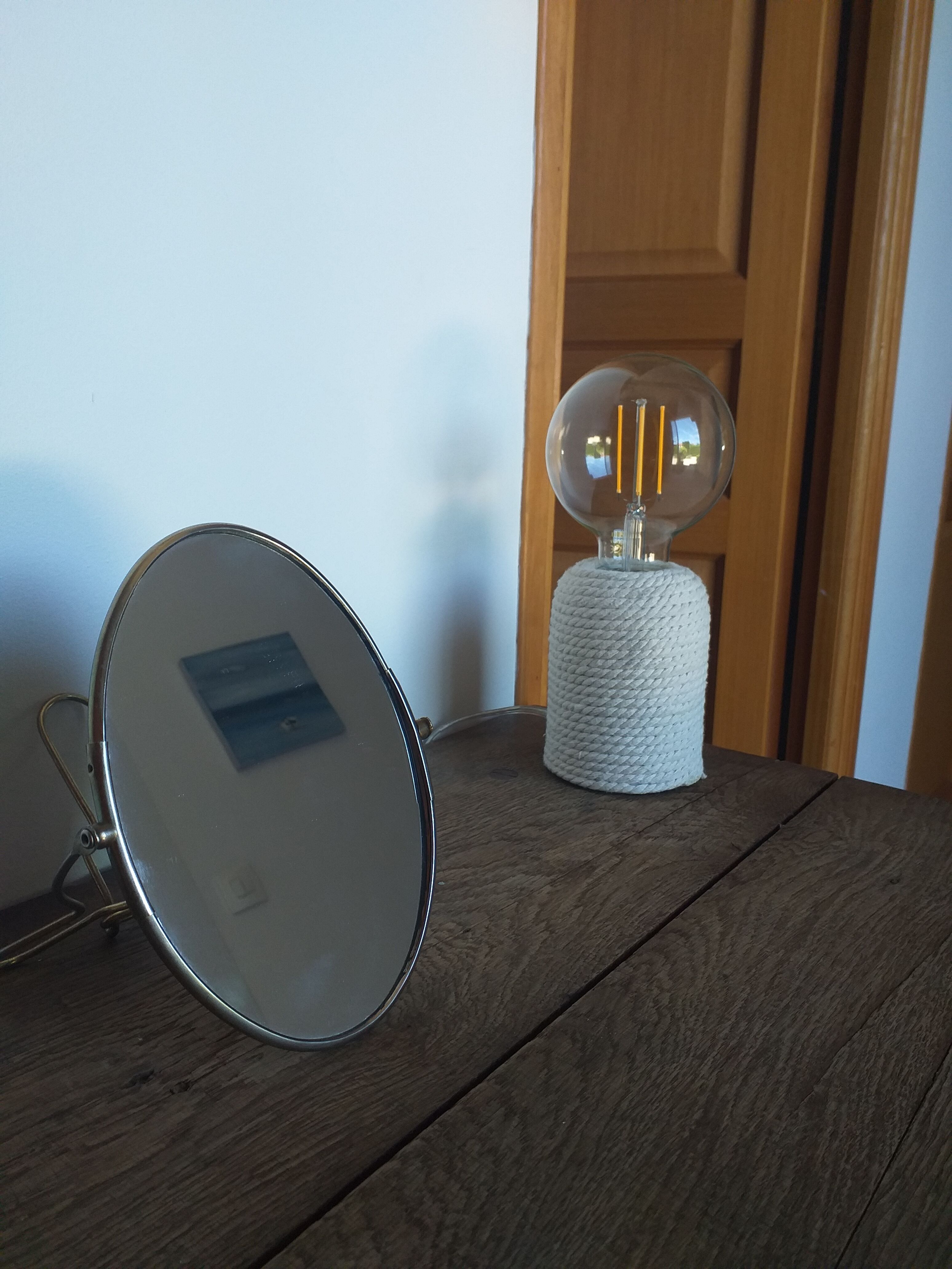 Vintage oval mirror on suspended stand