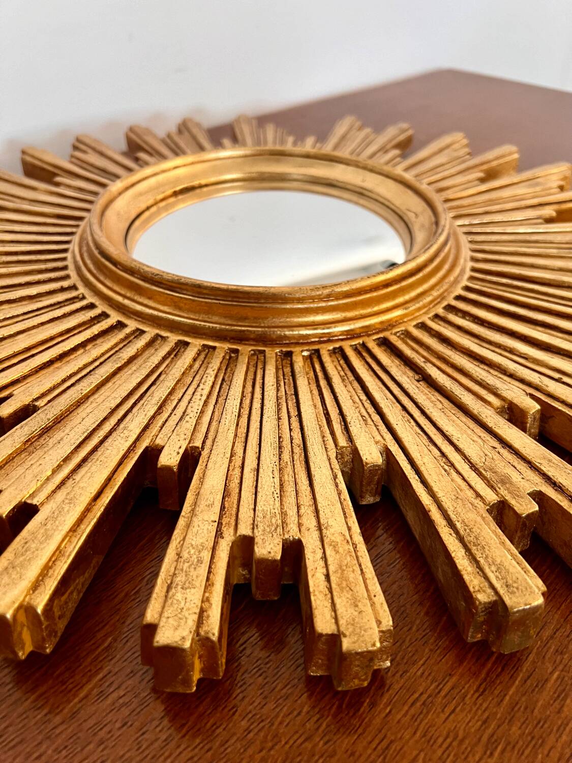 Old large golden sun mirror with rounded witch's eye in vintage resin from the 70s