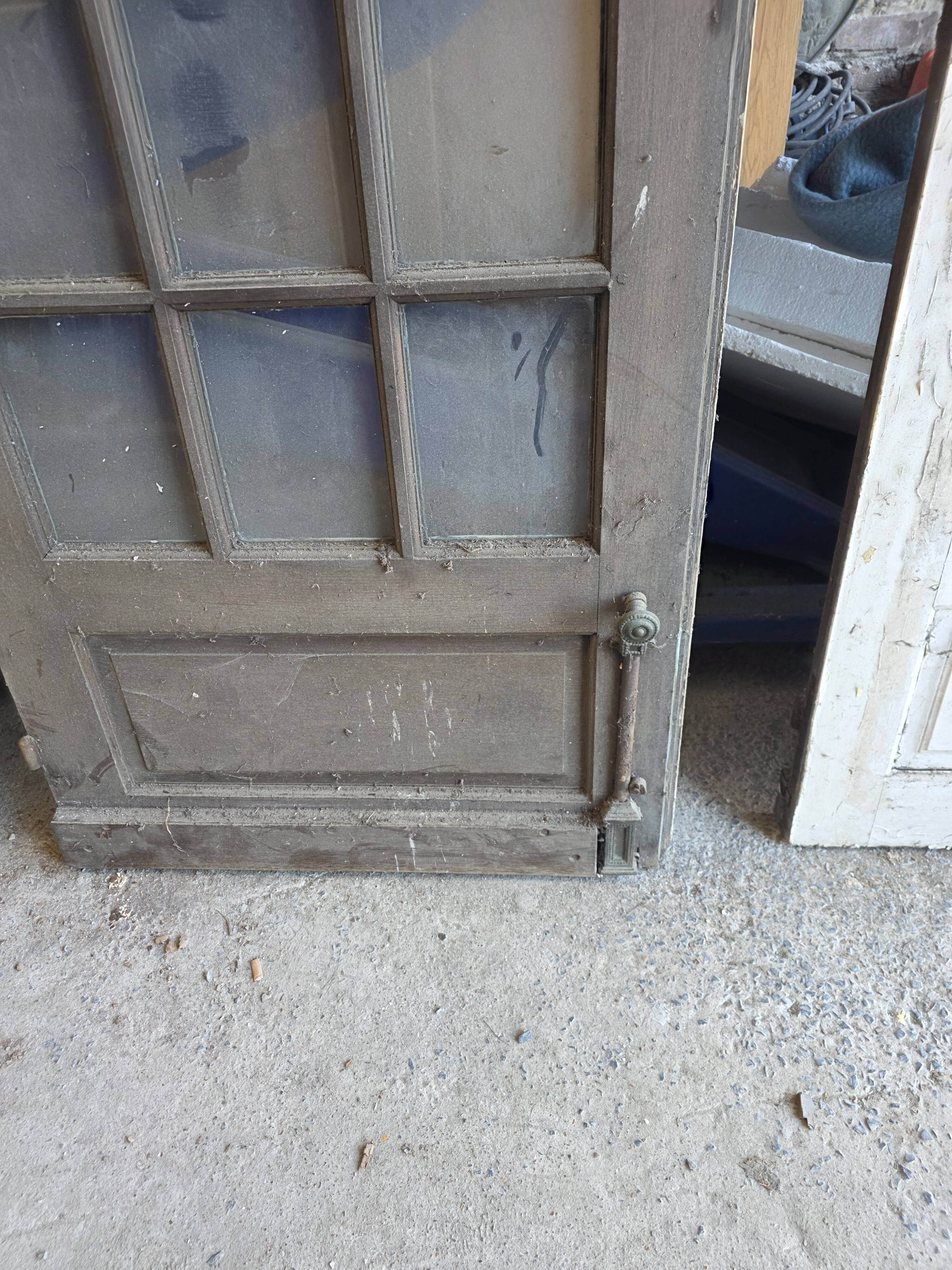 Two pairs of solid oak doors with small panes.