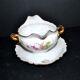 Vintage pouring sauce boat in floral porcelain with gilding.