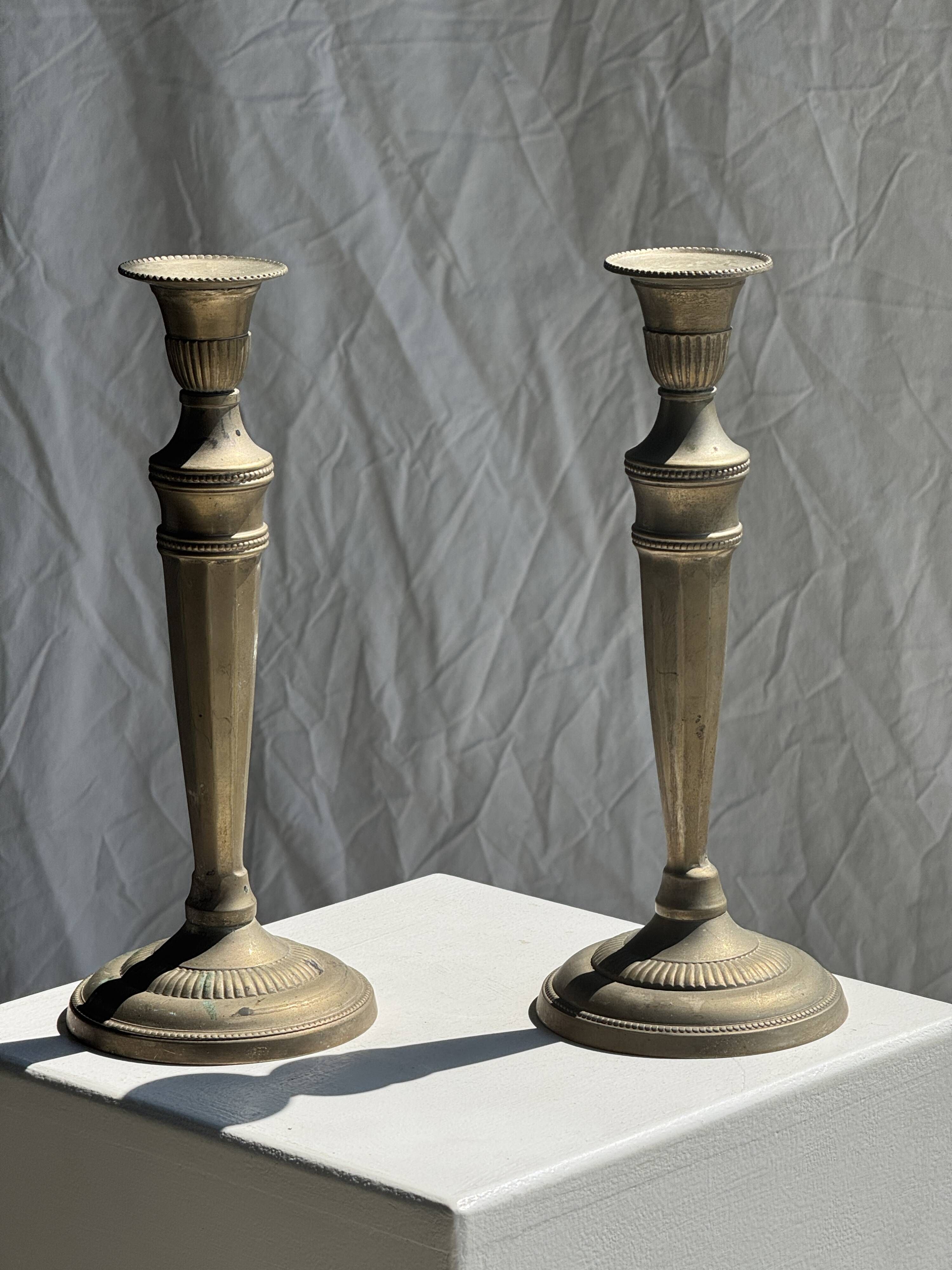 Pair of classic candlesticks in patinated gold metal H25
