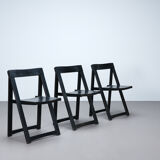 Set of three black folding chairs circa 1980