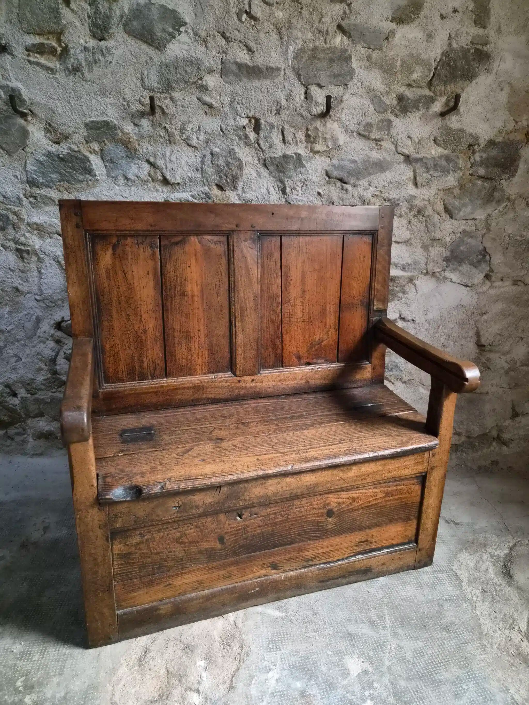Rustic French antique storage bench from the 18th century in walnut and pine.