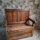 Rustic French antique storage bench from the 18th century in walnut and pine.