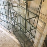 Pair of wrought iron and glass bookshelf shelves.