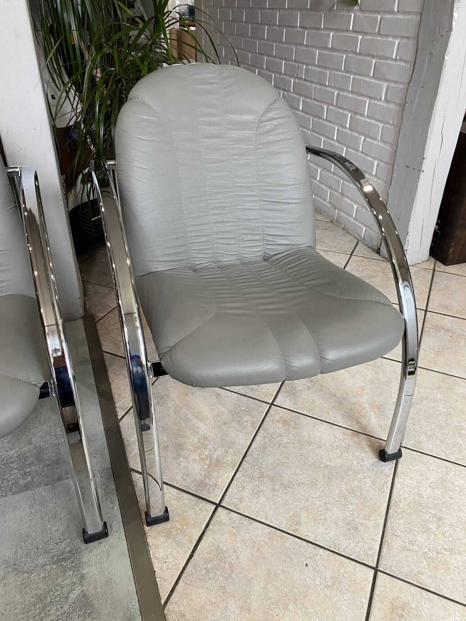 Pair of Souvignet armchairs, grey leather, chrome, 1980.